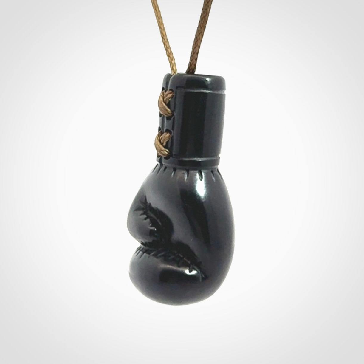 Hand carved boxing glove pendant made from black jade. The cord is adjustable so that you can wear this where it suits you best. We ship these worldwide and the postage is included in the price.