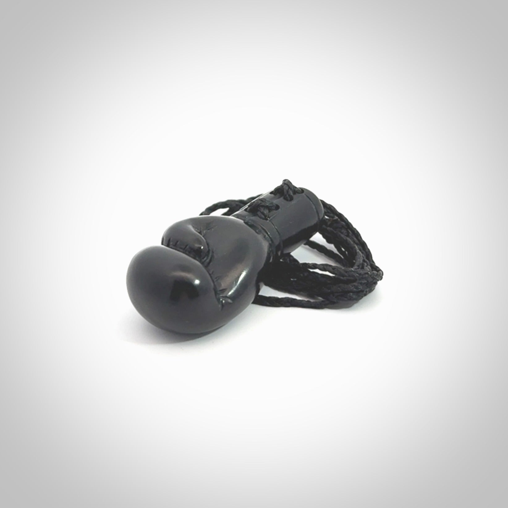 Hand carved boxing glove made from black jade. The cord is adjustable so that you can wear this where it suits you best. We ship these worldwide and the postage is included in the price.