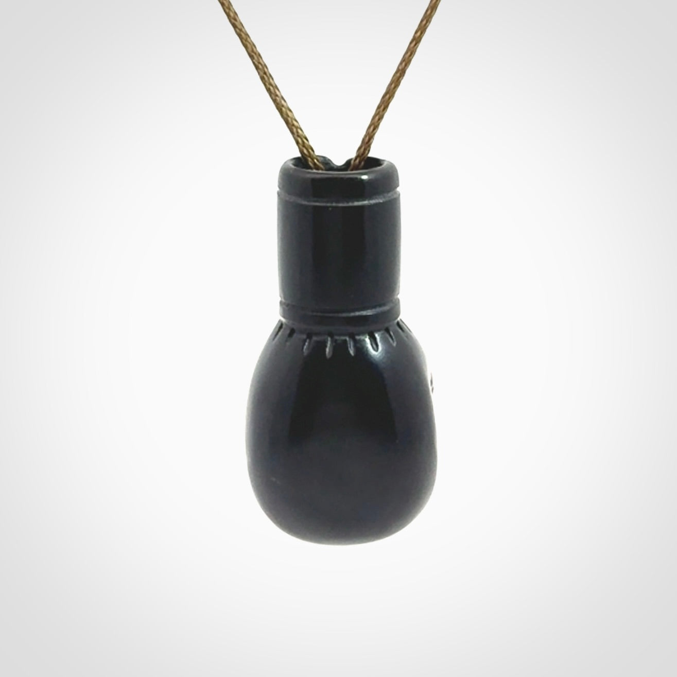 Hand carved boxing glove pendant made from black jade. The cord is adjustable so that you can wear this where it suits you best. We ship these worldwide and the postage is included in the price.