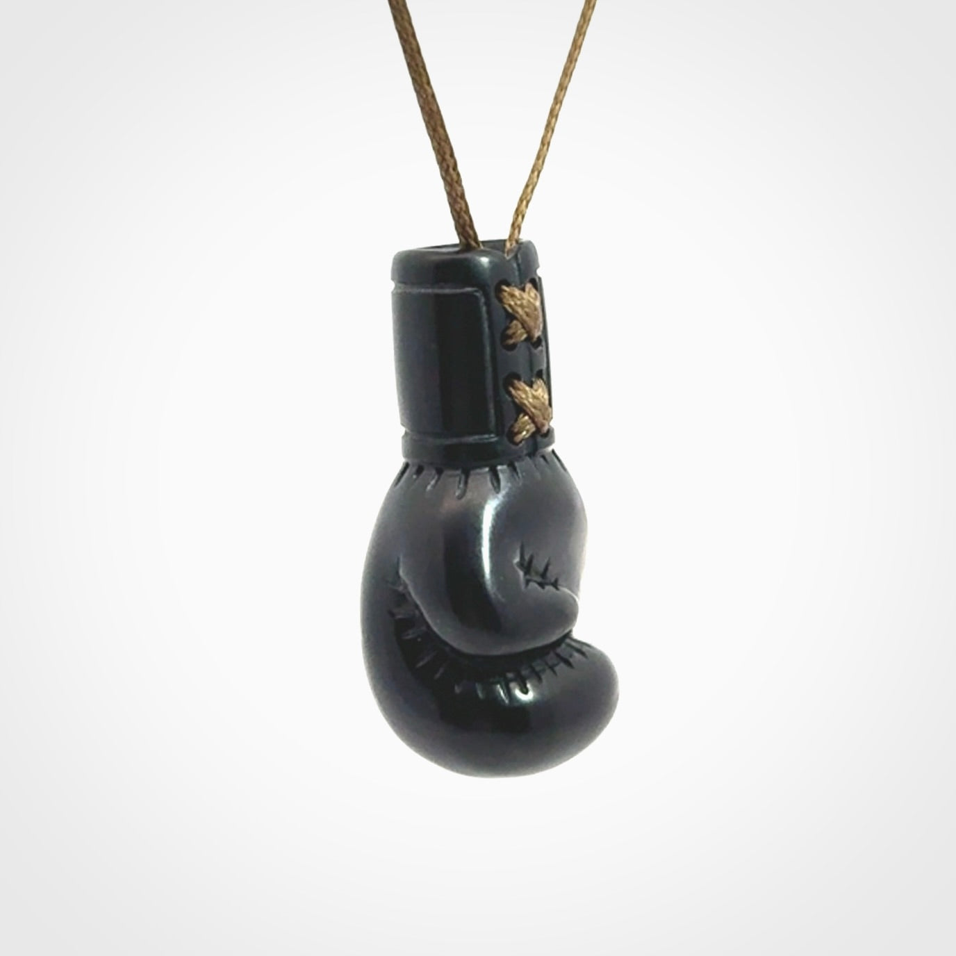 Hand carved boxing glove pendant made from black jade. The cord is adjustable so that you can wear this where it suits you best. We ship these worldwide and the postage is included in the price.