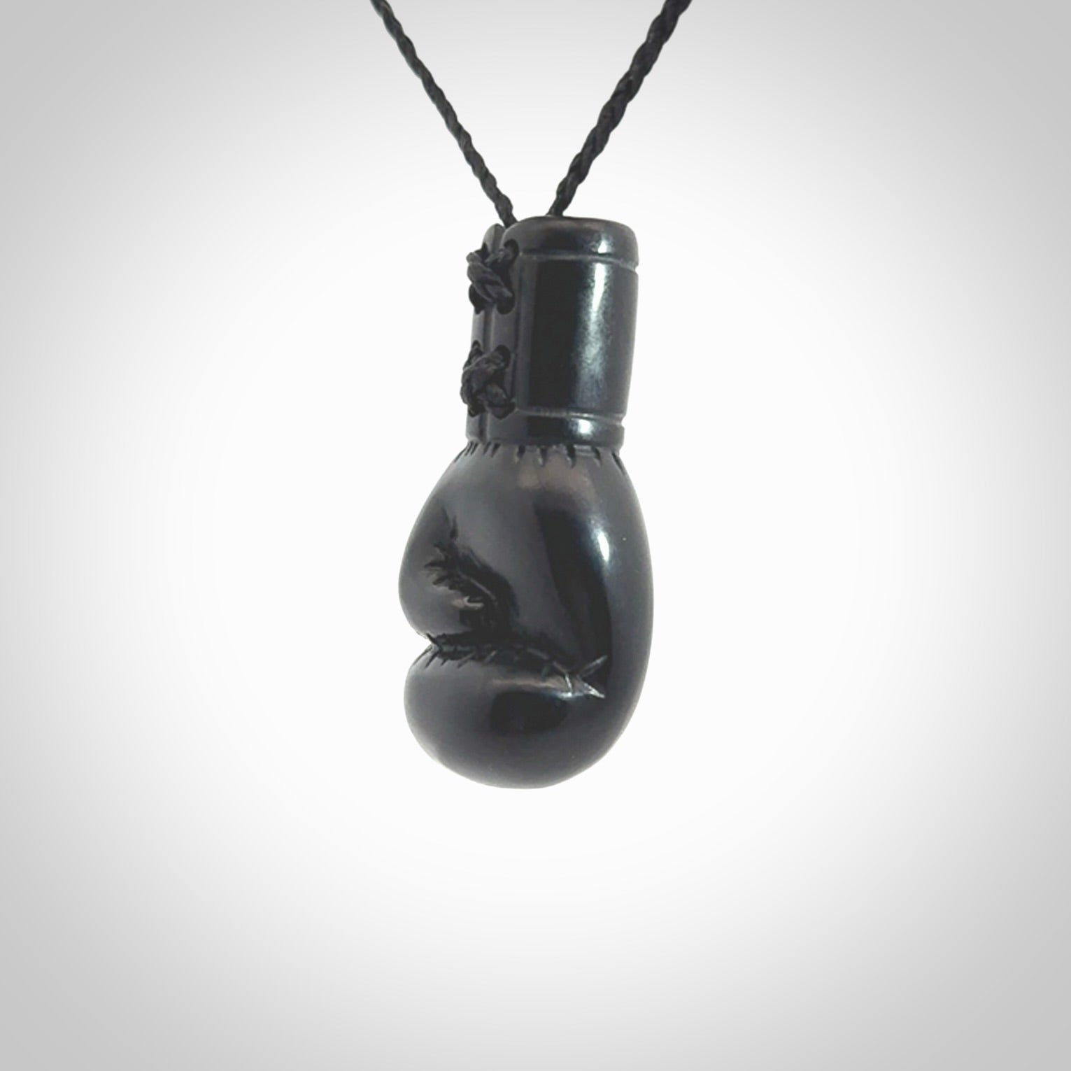 Hand carved boxing glove made from black jade. The cord is adjustable so that you can wear this where it suits you best. We ship these worldwide and the postage is included in the price.
