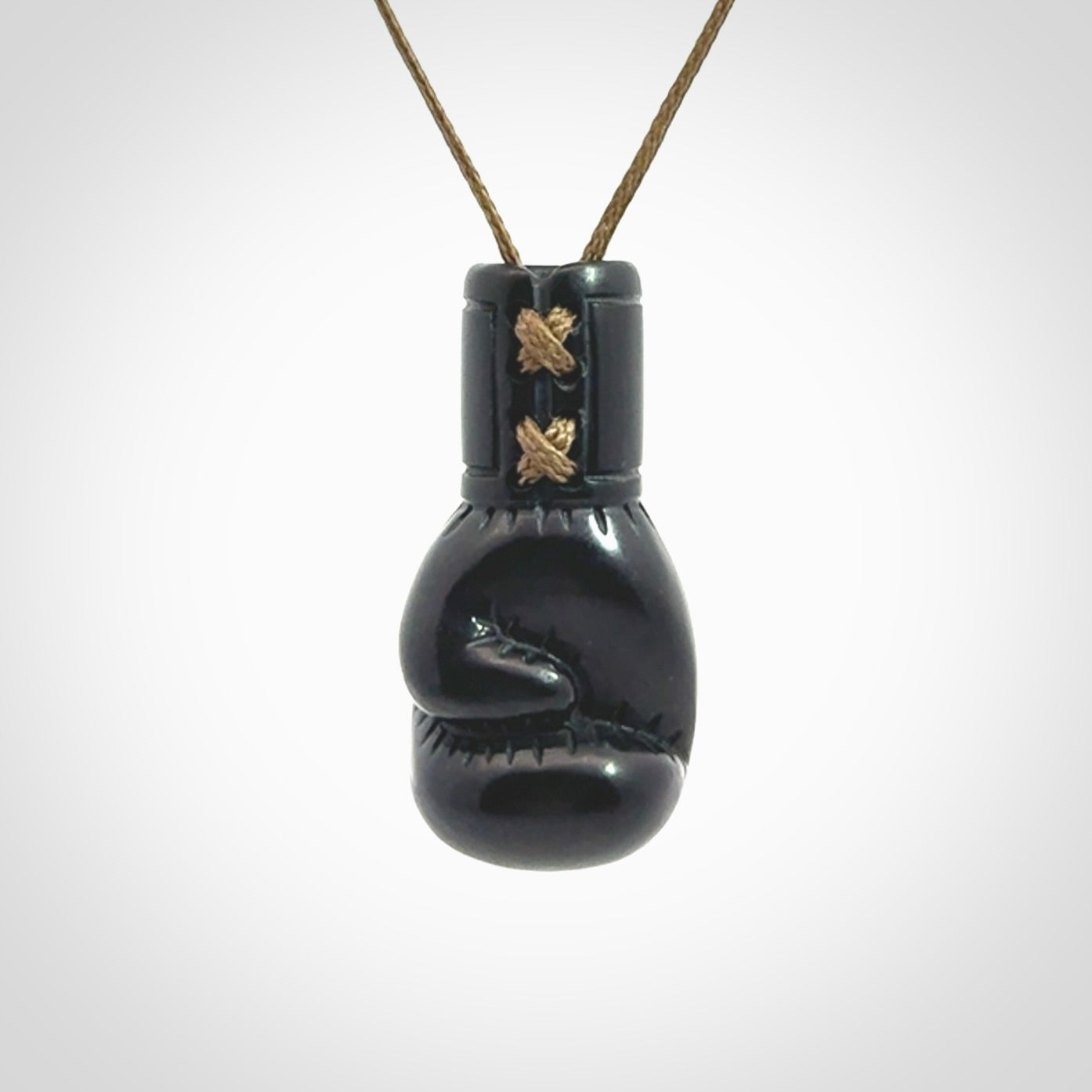 Hand carved boxing glove pendant made from black jade. The cord is adjustable so that you can wear this where it suits you best. We ship these worldwide and the postage is included in the price.