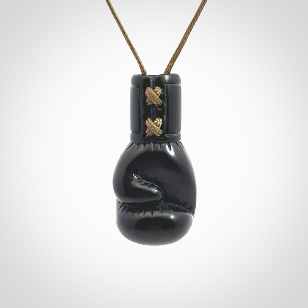 Hand carved boxing glove pendant made from black jade. The cord is adjustable so that you can wear this where it suits you best. We ship these worldwide and the postage is included in the price.