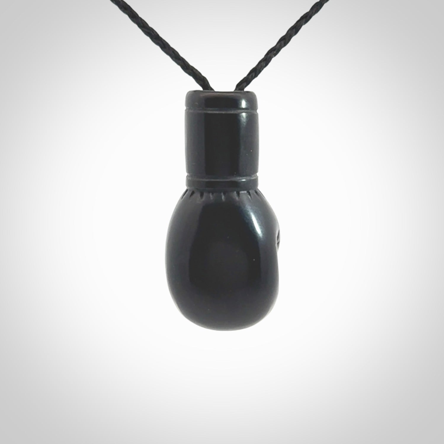 Hand carved boxing glove made from black jade. The cord is adjustable so that you can wear this where it suits you best. We ship these worldwide and the postage is included in the price.