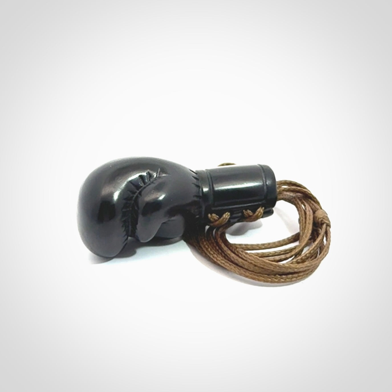 Hand carved boxing glove pendant made from black jade. The cord is adjustable so that you can wear this where it suits you best. We ship these worldwide and the postage is included in the price.