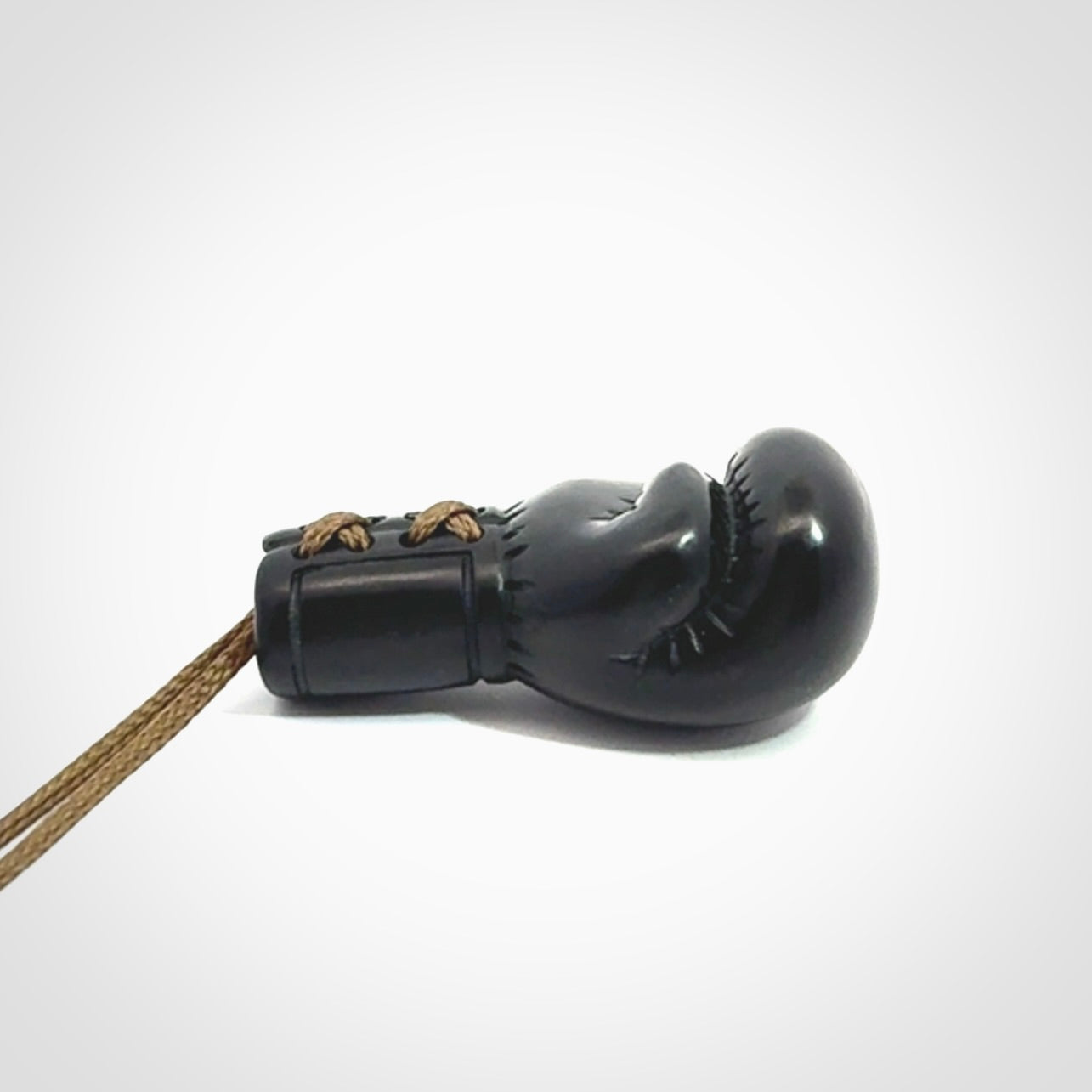 Hand carved boxing glove pendant made from black jade. The cord is adjustable so that you can wear this where it suits you best. We ship these worldwide and the postage is included in the price.