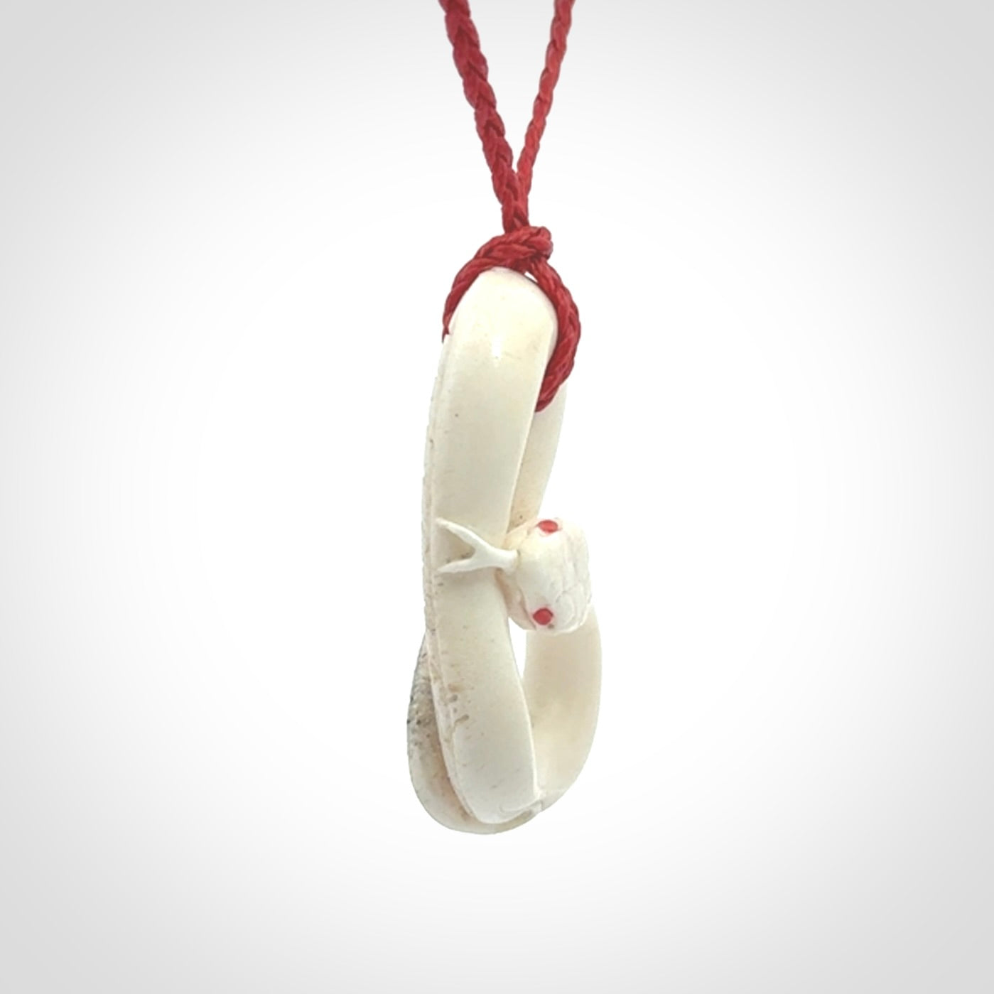 Hand carved red eyed white snake pendant made from Deer antler in New Zealand. Hand made by master bone carver Fumio Noguchi. Spectacular collectable work of art, made to wear. One only pendant, delivered to you at no extra cost with express courier.
