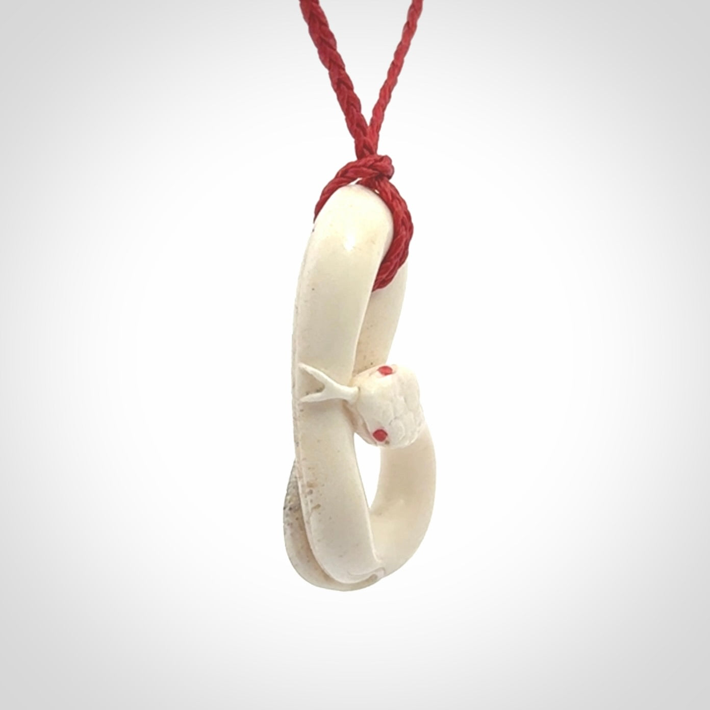 Hand carved red eyed white snake pendant made from Deer antler in New Zealand. Hand made by master bone carver Fumio Noguchi. Spectacular collectable work of art, made to wear. One only pendant, delivered to you at no extra cost with express courier.