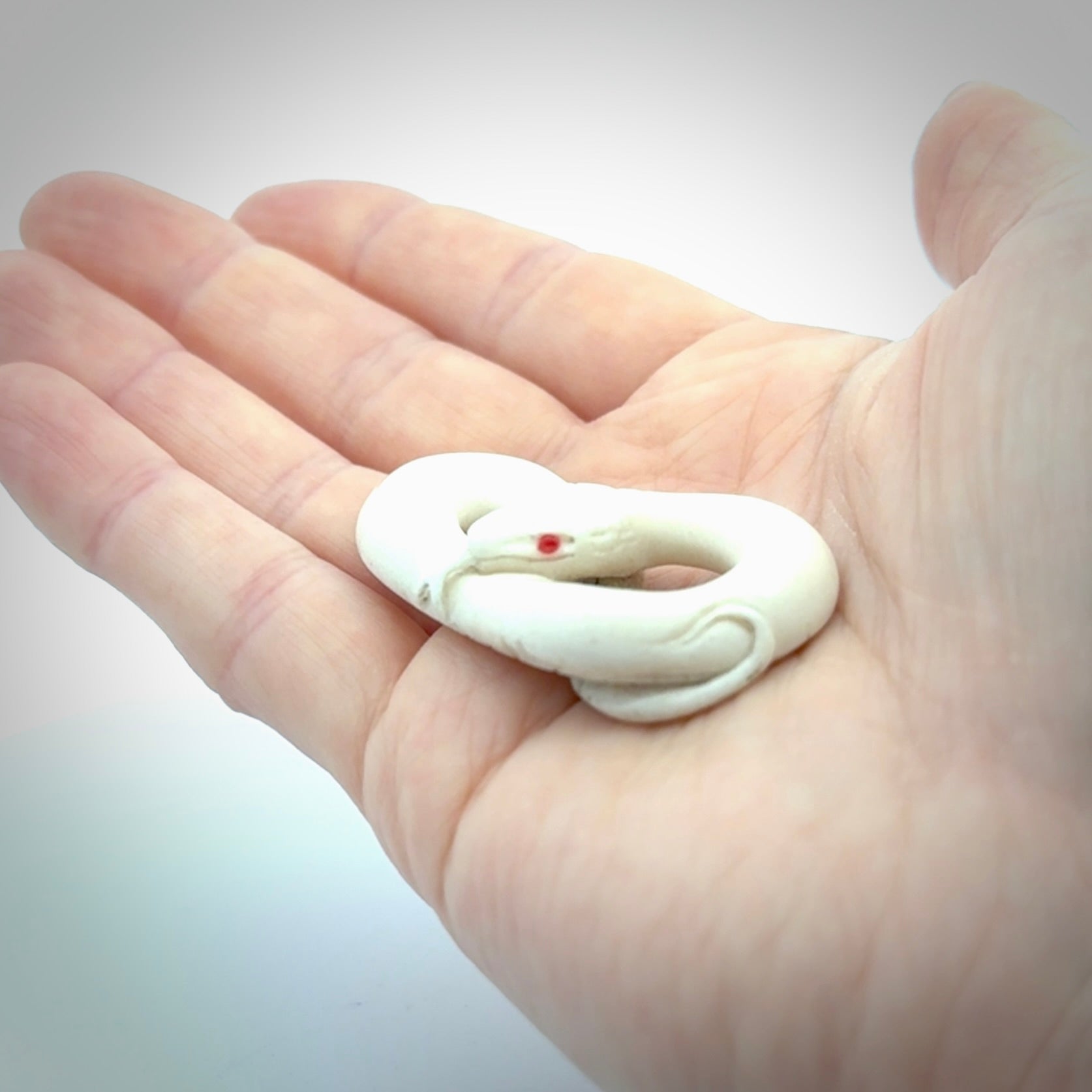 Hand carved red eyed white snake pendant made from Deer antler in New Zealand. Hand made by master bone carver Fumio Noguchi. Spectacular collectable work of art, made to wear. One only pendant, delivered to you at no extra cost with express courier.
