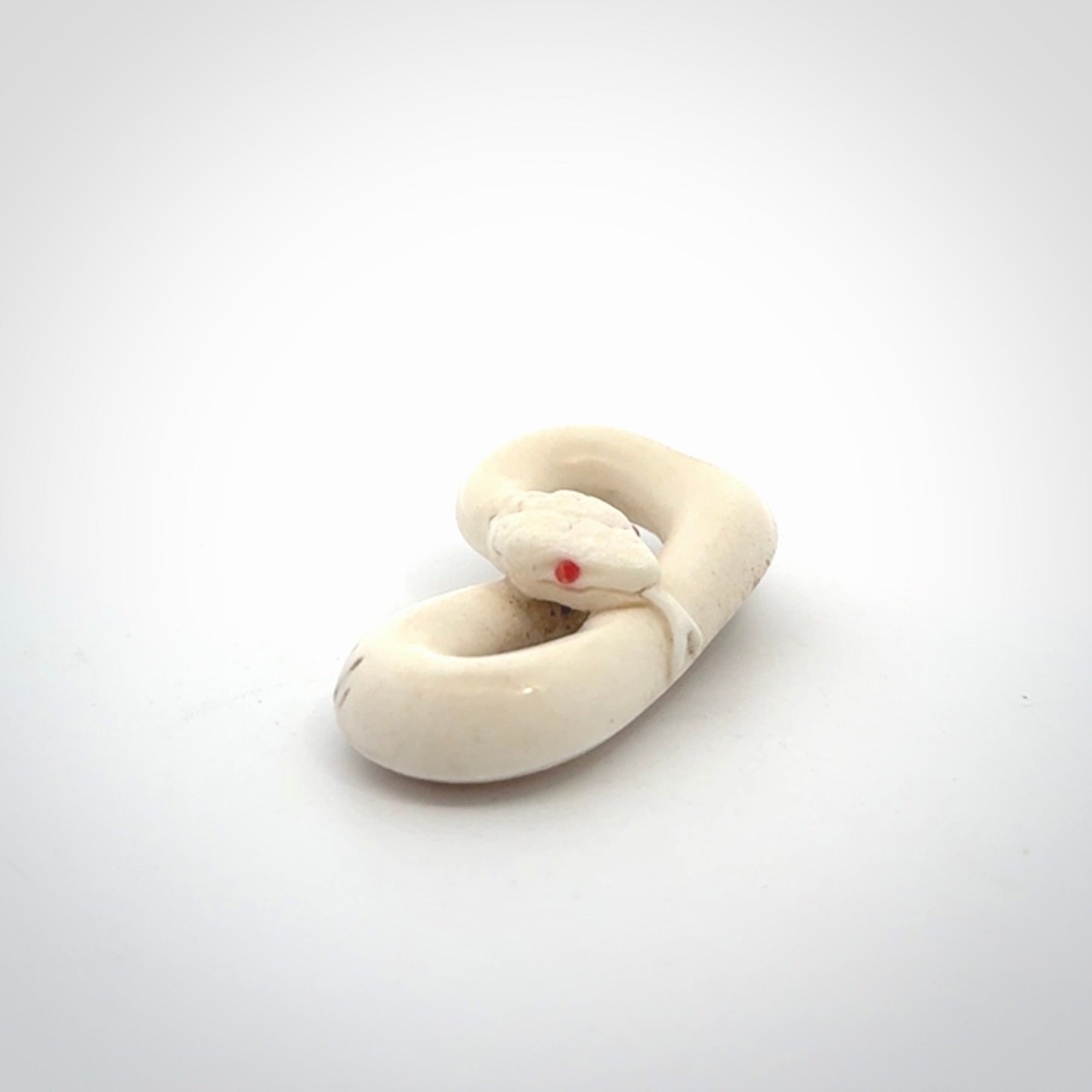 Hand carved white snake pendant made from Deer antler in New Zealand. Hand made by master bone carver Fumio Noguchi. Spectacular collectable work of art, made to wear. One only pendant, delivered to you at no extra cost with express courier.