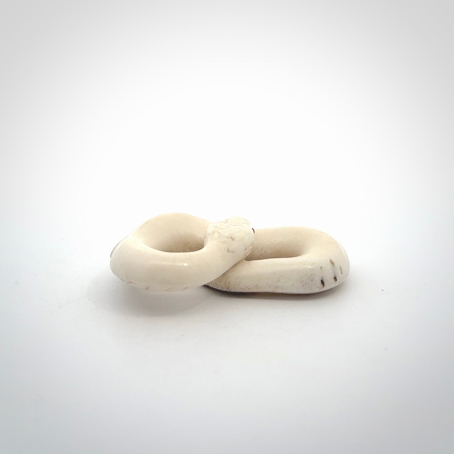 Hand carved red eyed white snake pendant made from Deer antler in New Zealand. Hand made by master bone carver Fumio Noguchi. Spectacular collectable work of art, made to wear. One only pendant, delivered to you at no extra cost with express courier.