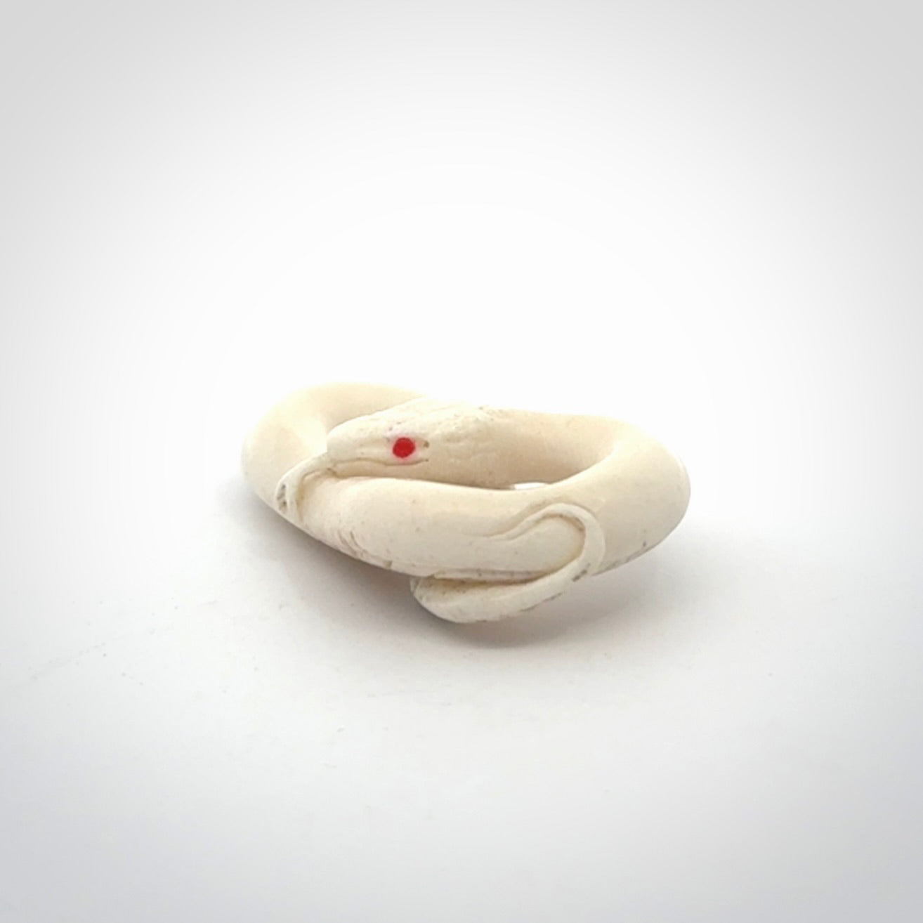 Hand carved red eyed white snake pendant made from Deer antler in New Zealand. Hand made by master bone carver Fumio Noguchi. Spectacular collectable work of art, made to wear. One only pendant, delivered to you at no extra cost with express courier.