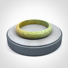 New Zealand flower jade bangle. This is carved from a solid piece of jade and polished to a mirror finish on the outside. The inside is a satin finish. The jade is high grade New Zealand Marsden and is a beautiful coloured stone.
