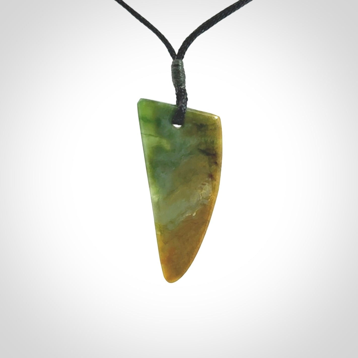 This photo shows a medium jade drop shaped pendant. It a a lovely varied green and orange New Zealand Marsden jade. The cord is black and is adjustable in length. One only medium, contemporary drop necklace from Jade.