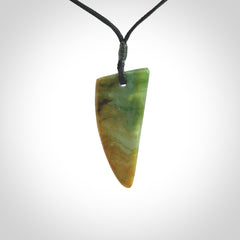 This photo shows a medium jade drop shaped pendant. It a a lovely varied green and orange New Zealand Marsden jade. The cord is black and is adjustable in length. One only medium, contemporary drop necklace from Jade.