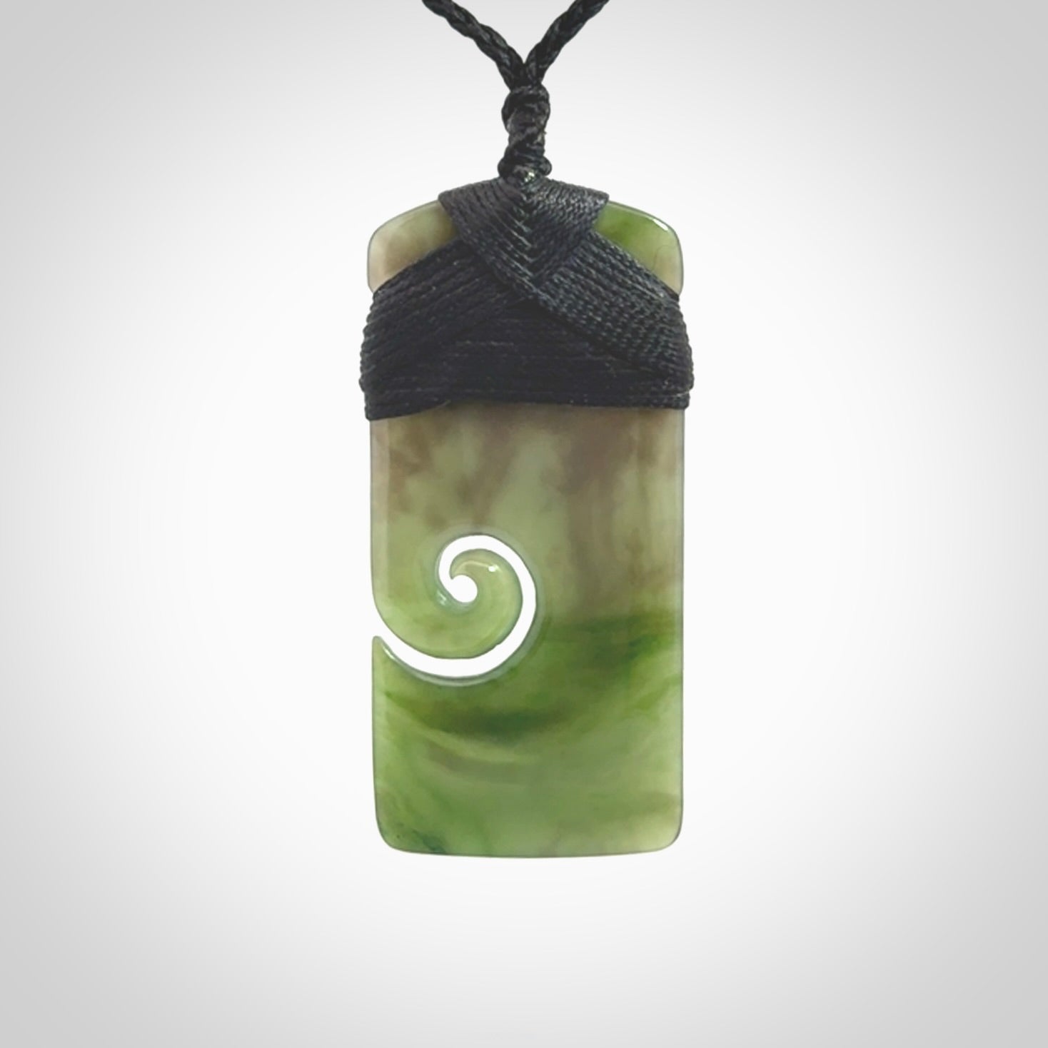 British Coloumbian jade toki koru pendant. Hand carved in New Zealand. Hand made British Coloumbian Jade jewellery. Provided with an adjustable cord and packaged in a woven kete pouch.