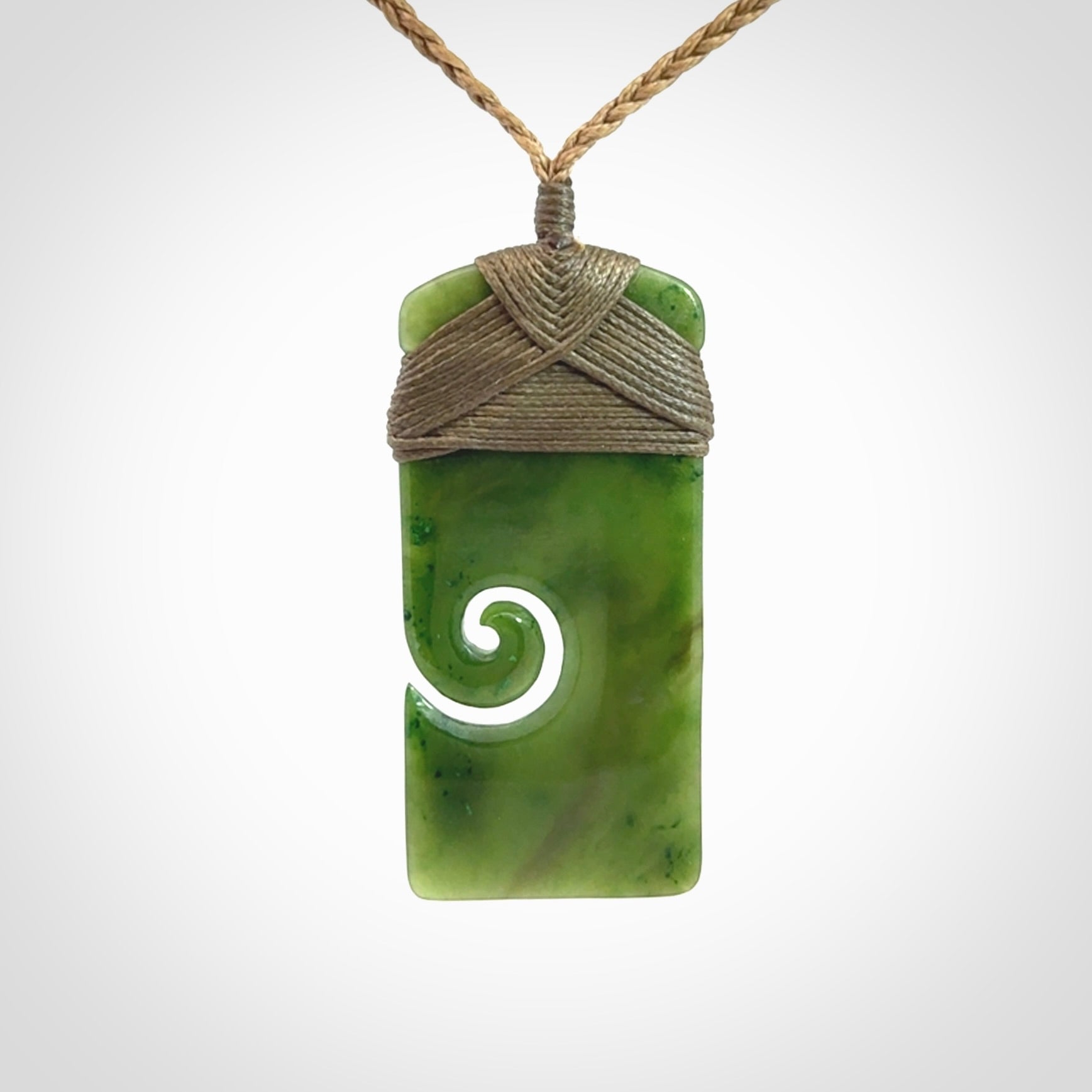 Hand carved British Columbian Jade Toki with koru pendant