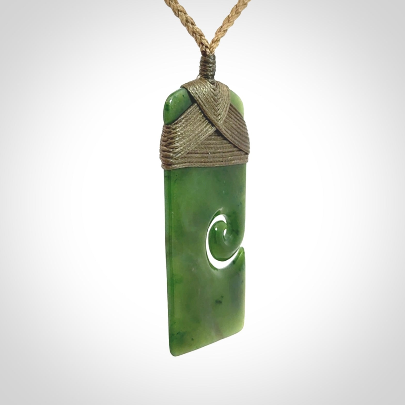 Hand carved British Columbian Jade Toki with koru pendant