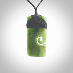 British Coloumbian jade toki koru pendant. Hand carved in New Zealand. Hand made British Coloumbian Jade jewellery. Provided with an adjustable cord and packaged in a woven kete pouch.