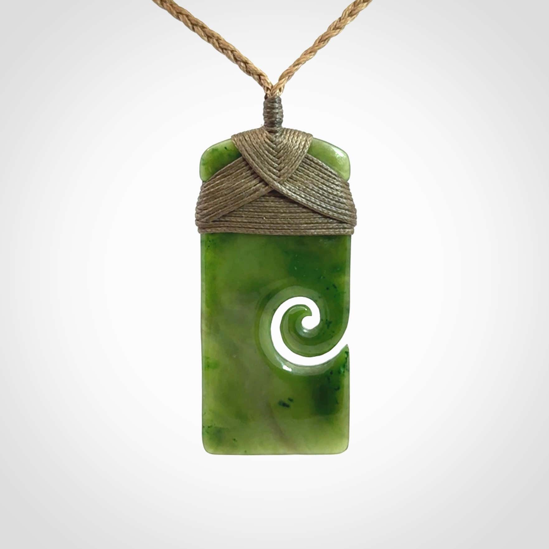 Hand carved British Columbian Jade Toki with koru pendant