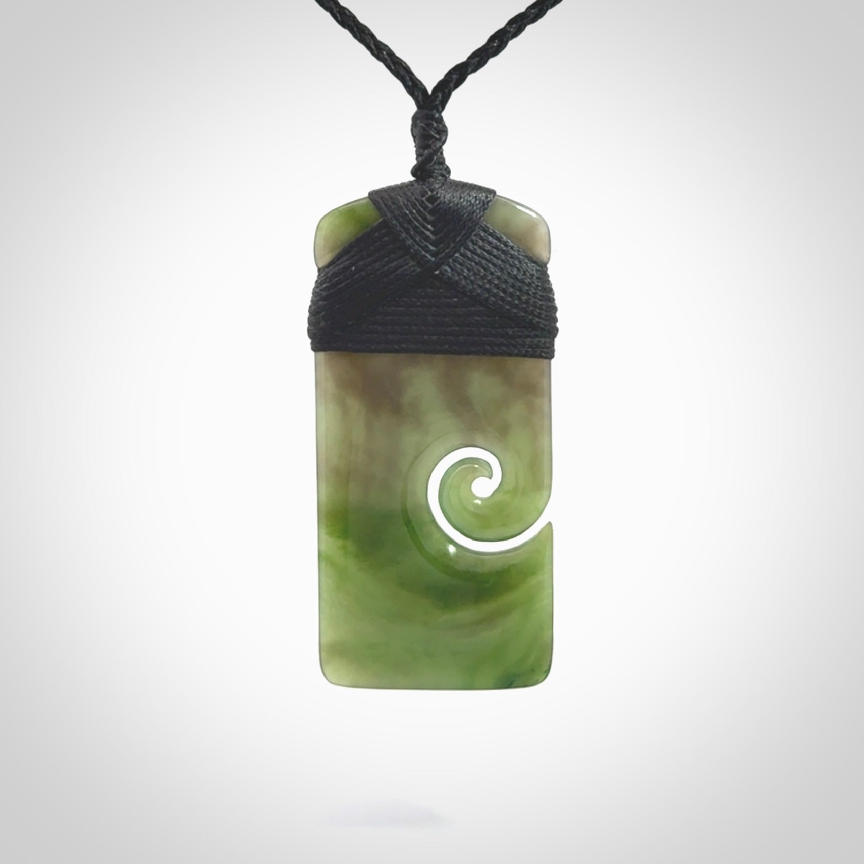 British Coloumbian jade toki koru pendant. Hand carved in New Zealand. Hand made British Coloumbian Jade jewellery. Provided with an adjustable cord and packaged in a woven kete pouch.
