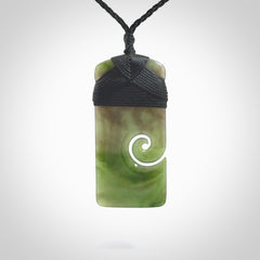 British Coloumbian jade toki koru pendant. Hand carved in New Zealand. Hand made British Coloumbian Jade jewellery. Provided with an adjustable cord and packaged in a woven kete pouch.
