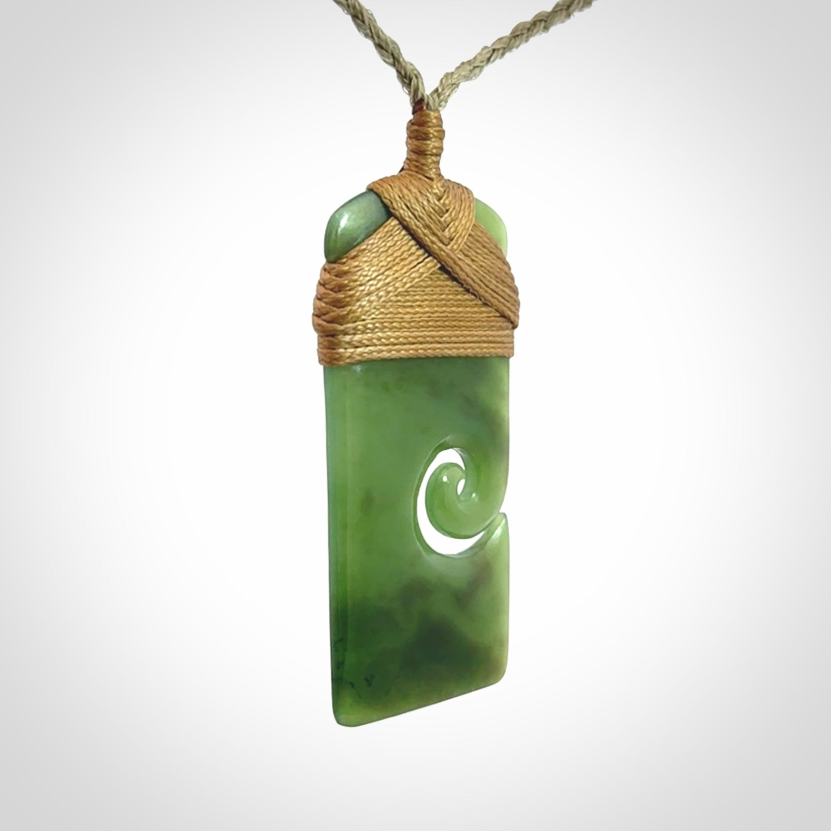 Hand carved British Columbian Jade Toki with koru pendant