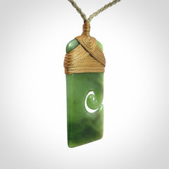 Hand carved British Columbian Jade Toki with koru pendant