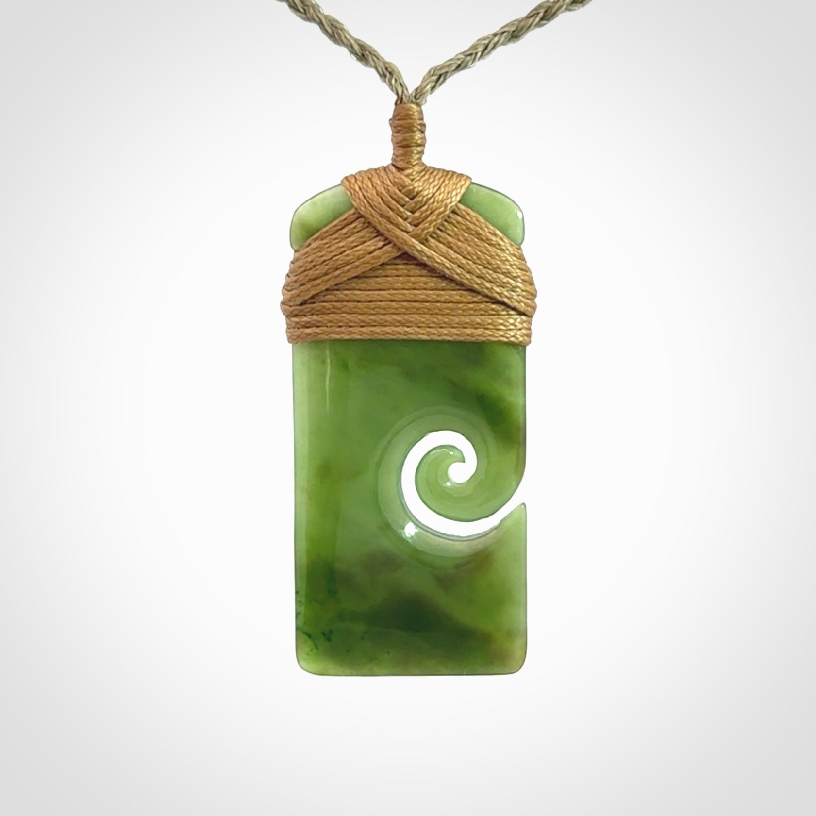 Hand carved British Columbian Jade Toki with koru pendant