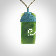 British Coloumbian jade toki koru pendant. Hand carved in New Zealand. Hand made British Coloumbian Jade jewellery. Provided with an adjustable cord and packaged in a woven kete pouch.