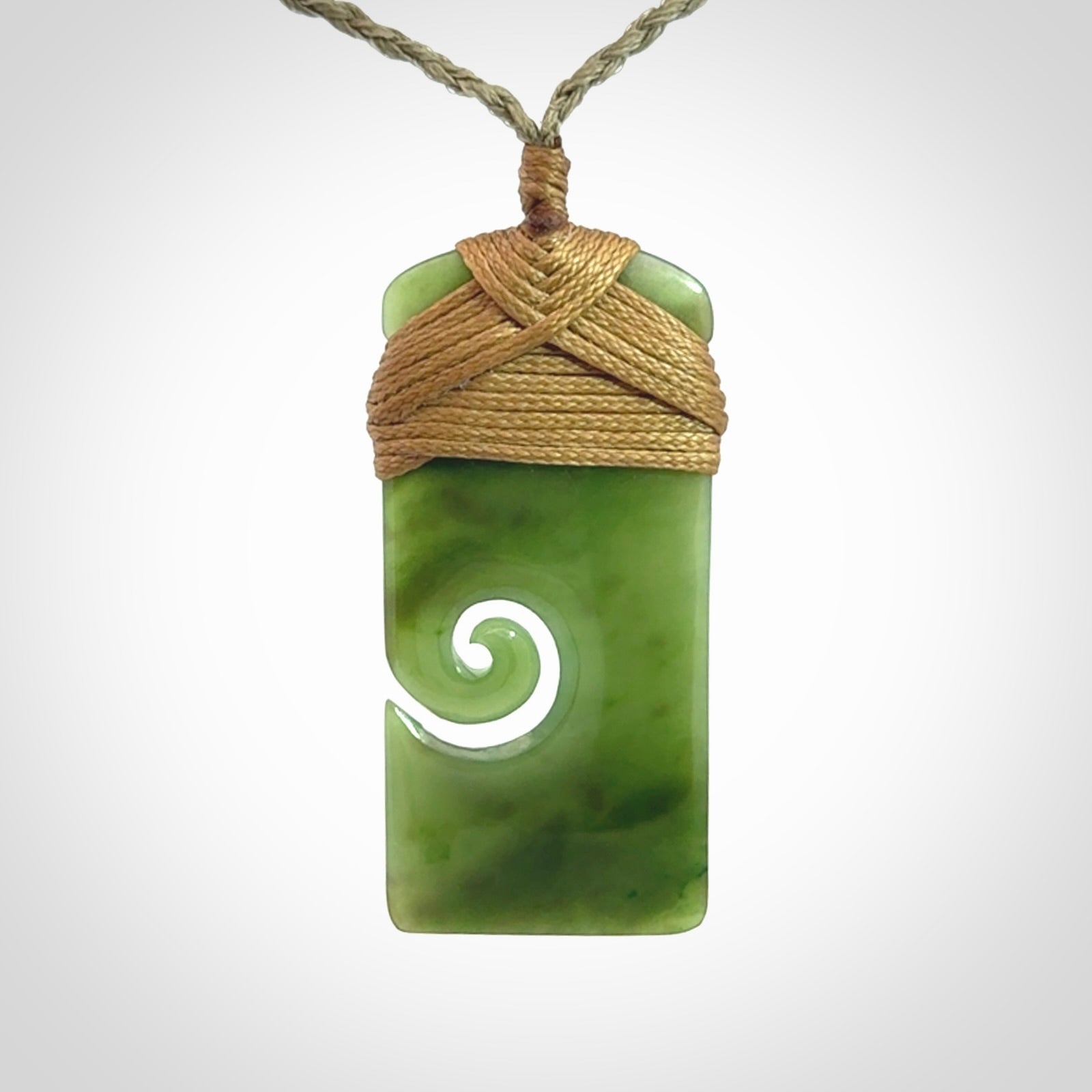 Hand carved British Columbian Jade Toki with koru pendant