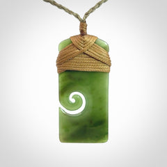 Hand carved British Columbian Jade Toki with koru pendant