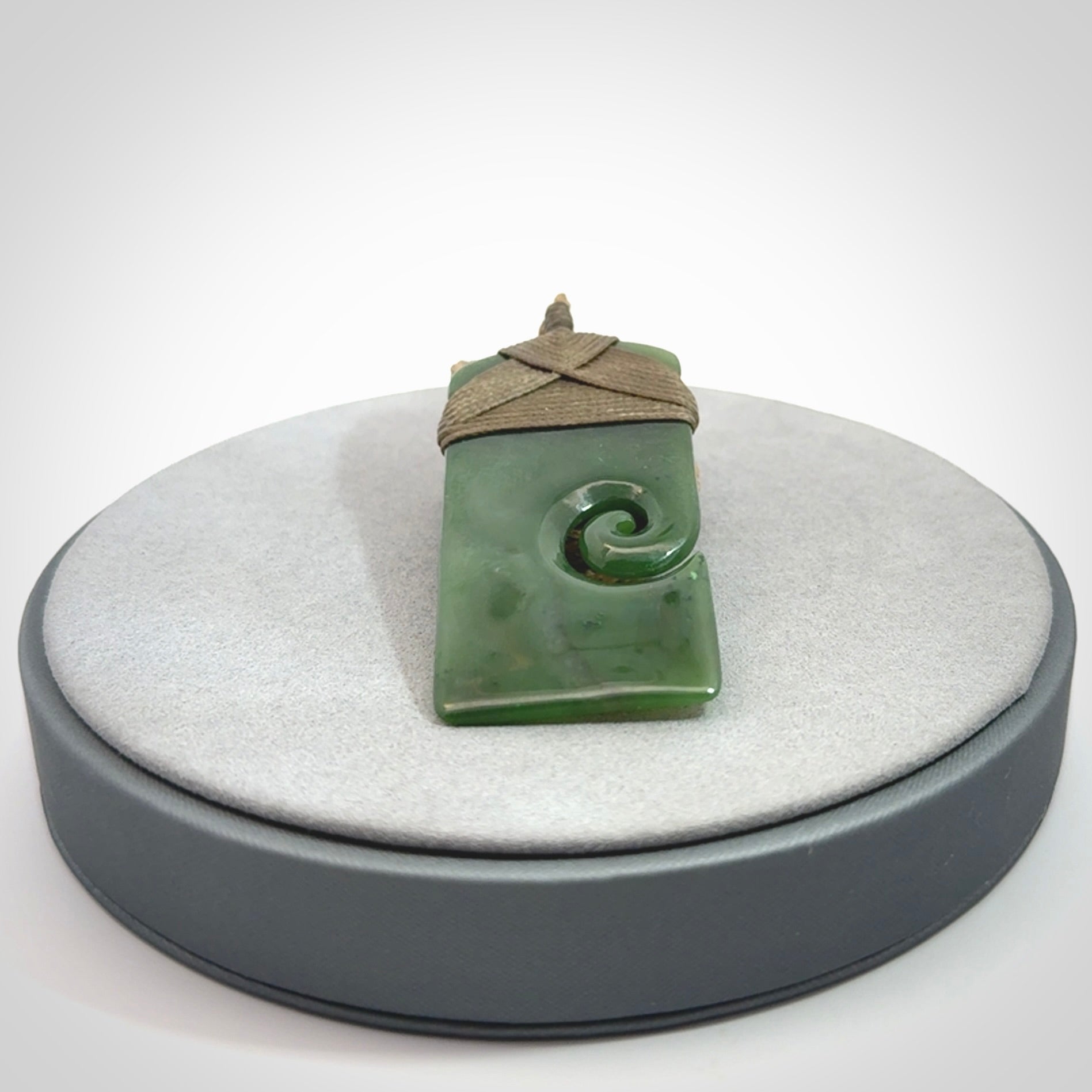 Hand carved British Columbian Jade Toki with koru pendant