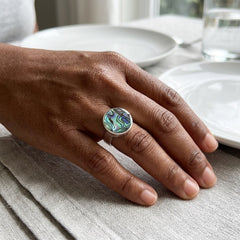 Hand wearing paua shell ring