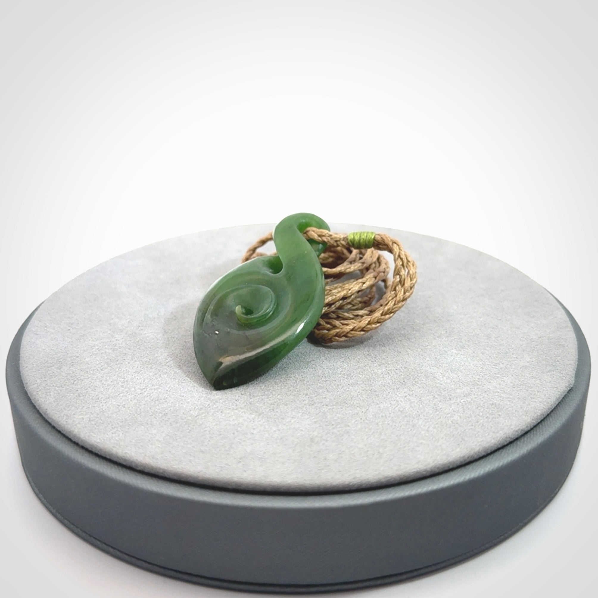 Ross Crump twist with koru pendant. Hand carved from rare New Zealand jade this is a beautiful pounamu pendant. The cord is length adjustable.