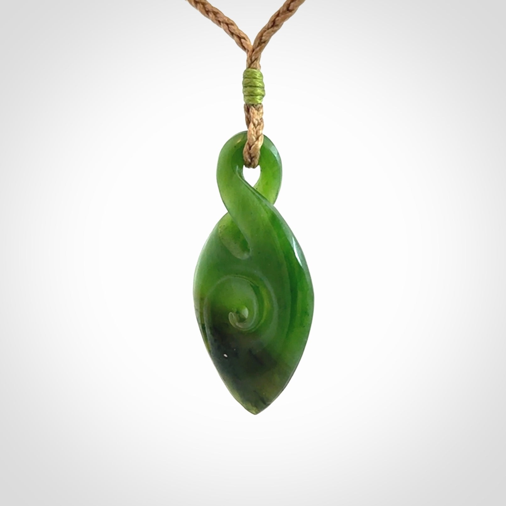 Ross Crump twist with koru pendant. Hand carved from rare New Zealand jade this is a beautiful pounamu pendant. The cord is length adjustable.