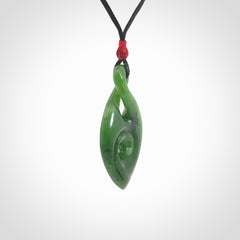 Ross Crump twist with koru pendant. Hand carved from rare New Zealand jade this is a beautiful pounamu pendant. The cord is length adjustable. It has a little spiral floret at the top of the pendant.