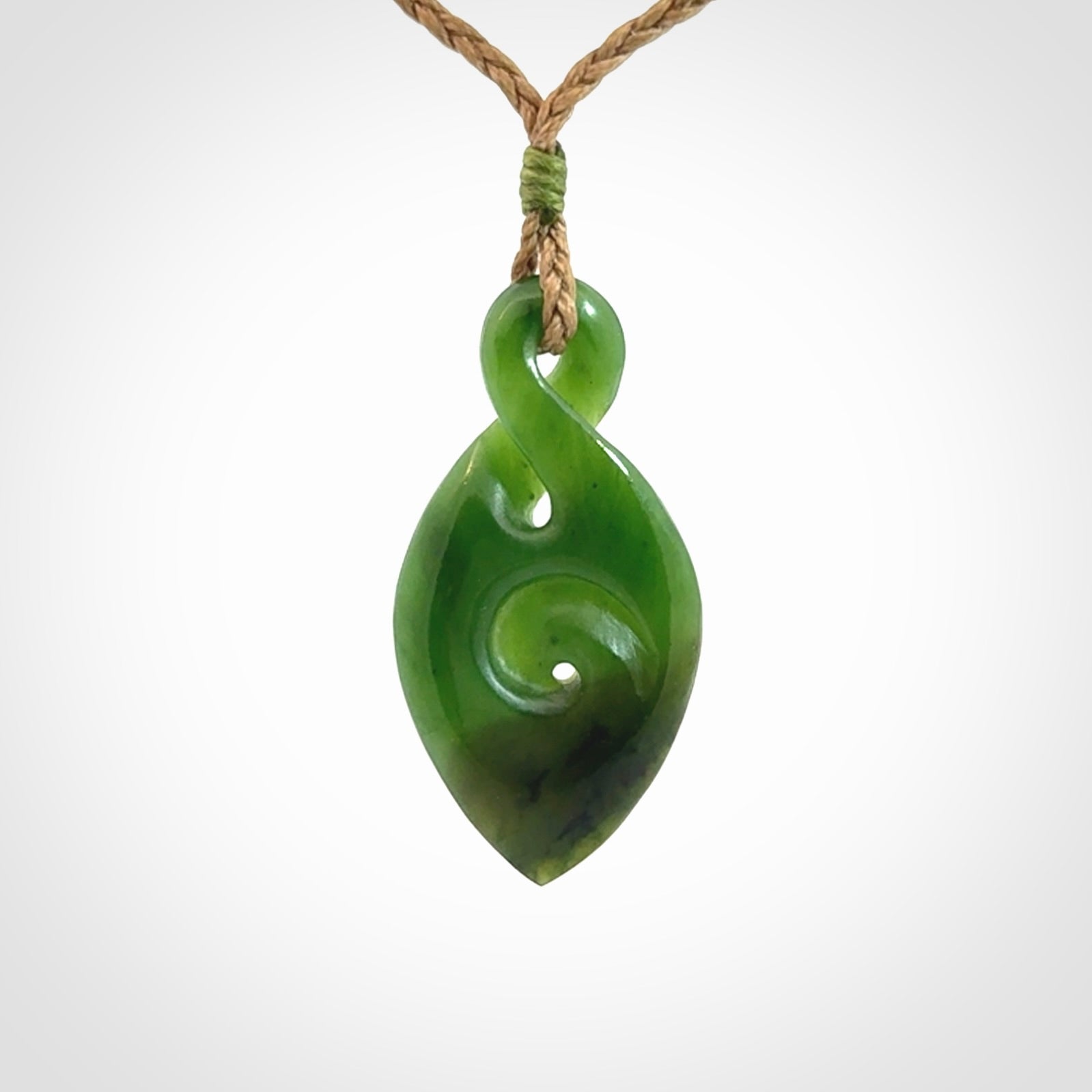 Ross Crump twist with koru pendant. Hand carved from rare New Zealand jade this is a beautiful pounamu pendant. The cord is length adjustable.