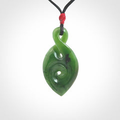Ross Crump twist with koru pendant. Hand carved from rare New Zealand jade this is a beautiful pounamu pendant. The cord is length adjustable. It has a little spiral floret at the top of the pendant.