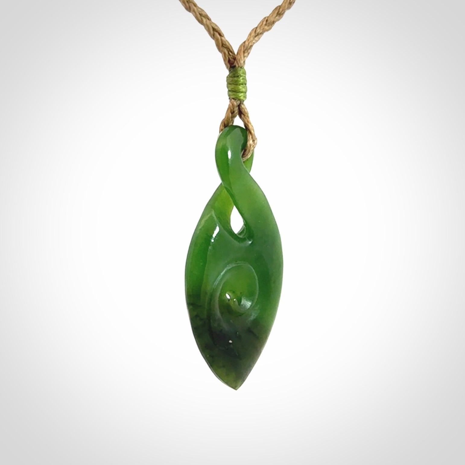 Ross Crump twist with koru pendant. Hand carved from rare New Zealand jade this is a beautiful pounamu pendant. The cord is length adjustable.