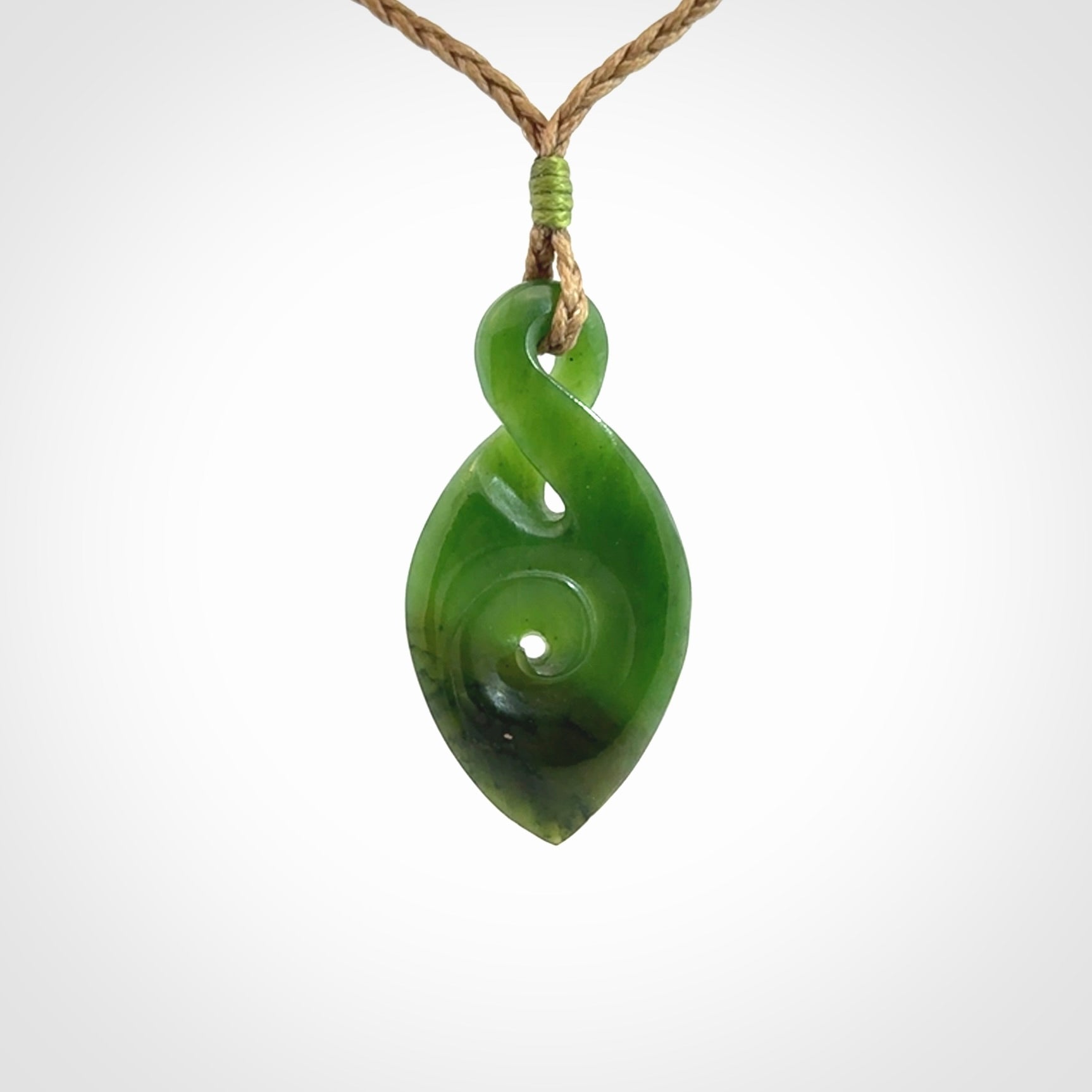 Ross Crump twist with koru pendant. Hand carved from rare New Zealand jade this is a beautiful pounamu pendant. The cord is length adjustable.