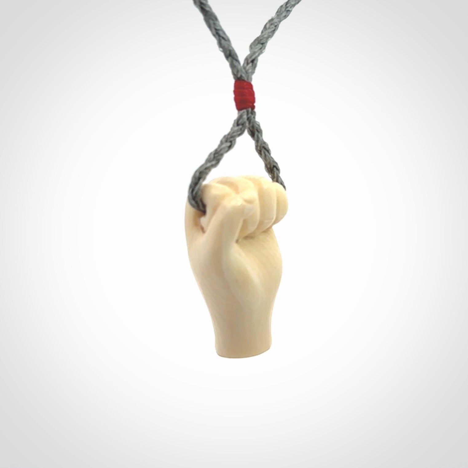 Hand carved fist pendant symbolising strength and hope. Carved by NZ Pacific from ancient woolly mammoth tusk.