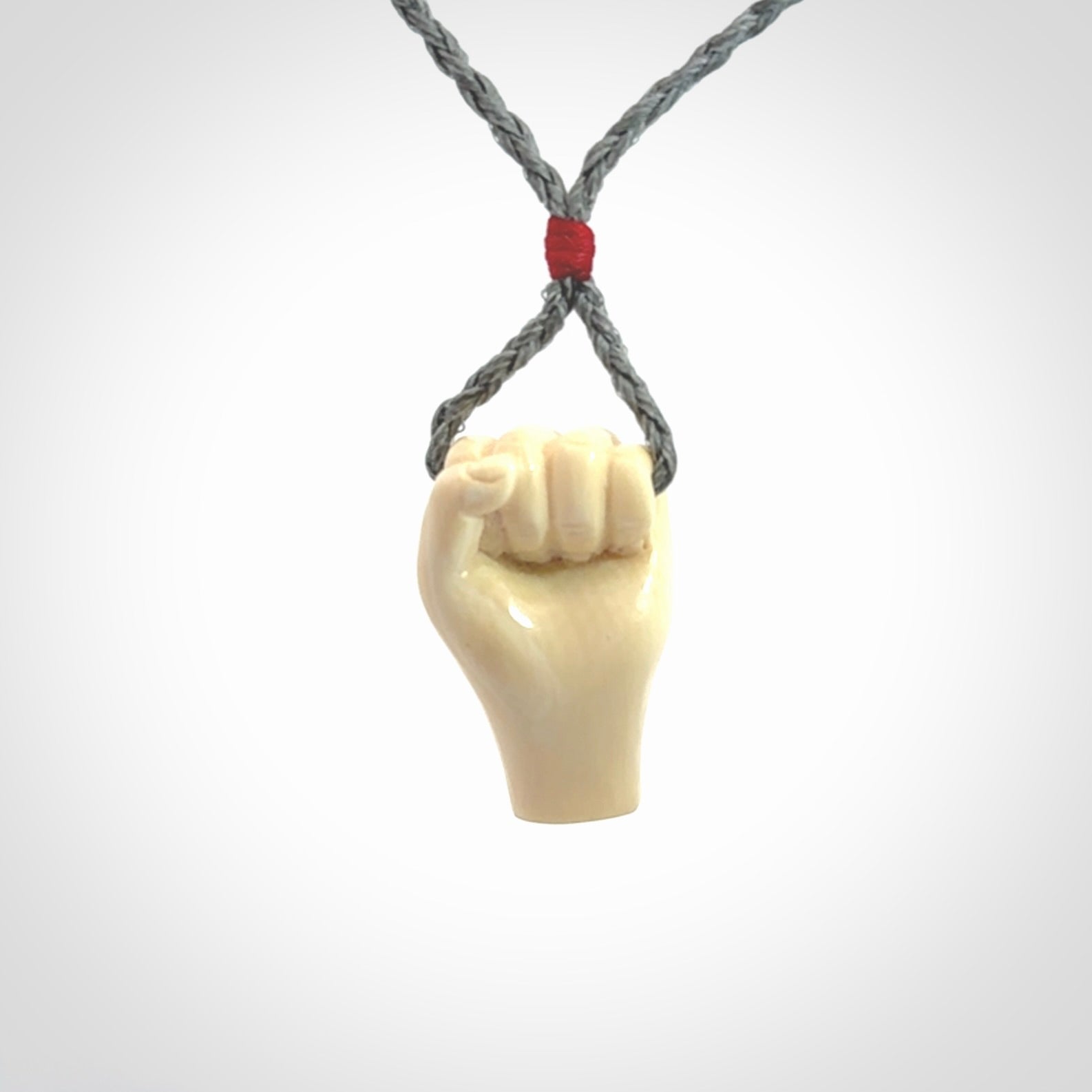 Hand carved fist pendant symbolising strength and hope. Carved by NZ Pacific from ancient woolly mammoth tusk.