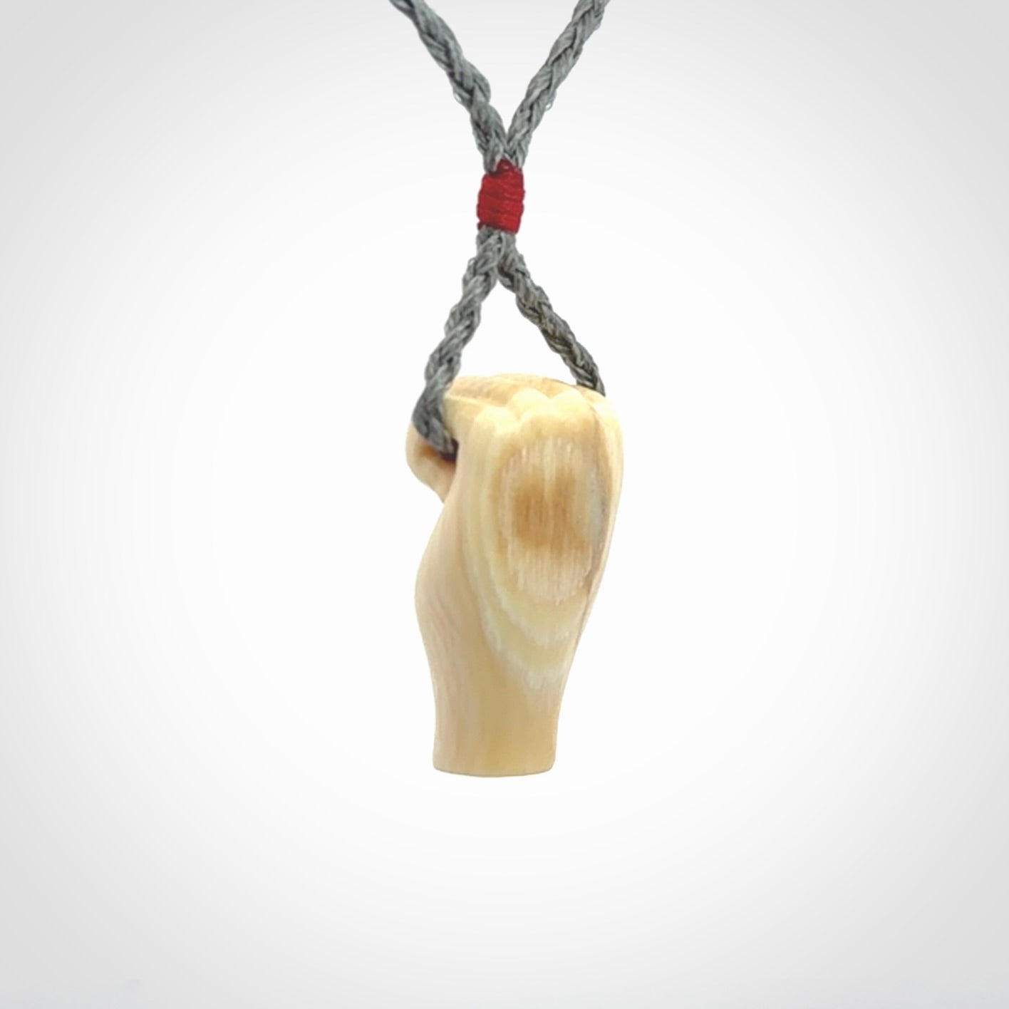 Hand carved fist pendant symbolising strength and hope. Carved by NZ Pacific from ancient woolly mammoth tusk.