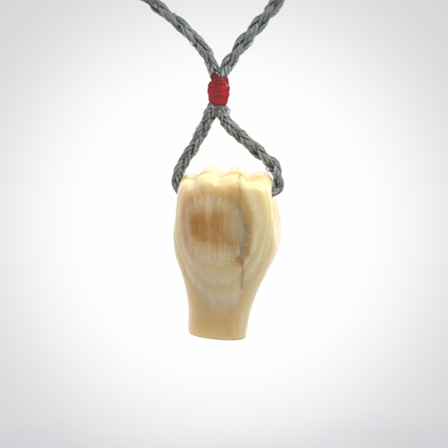 Hand carved fist pendant symbolising strength and hope. Carved by NZ Pacific from ancient woolly mammoth tusk.