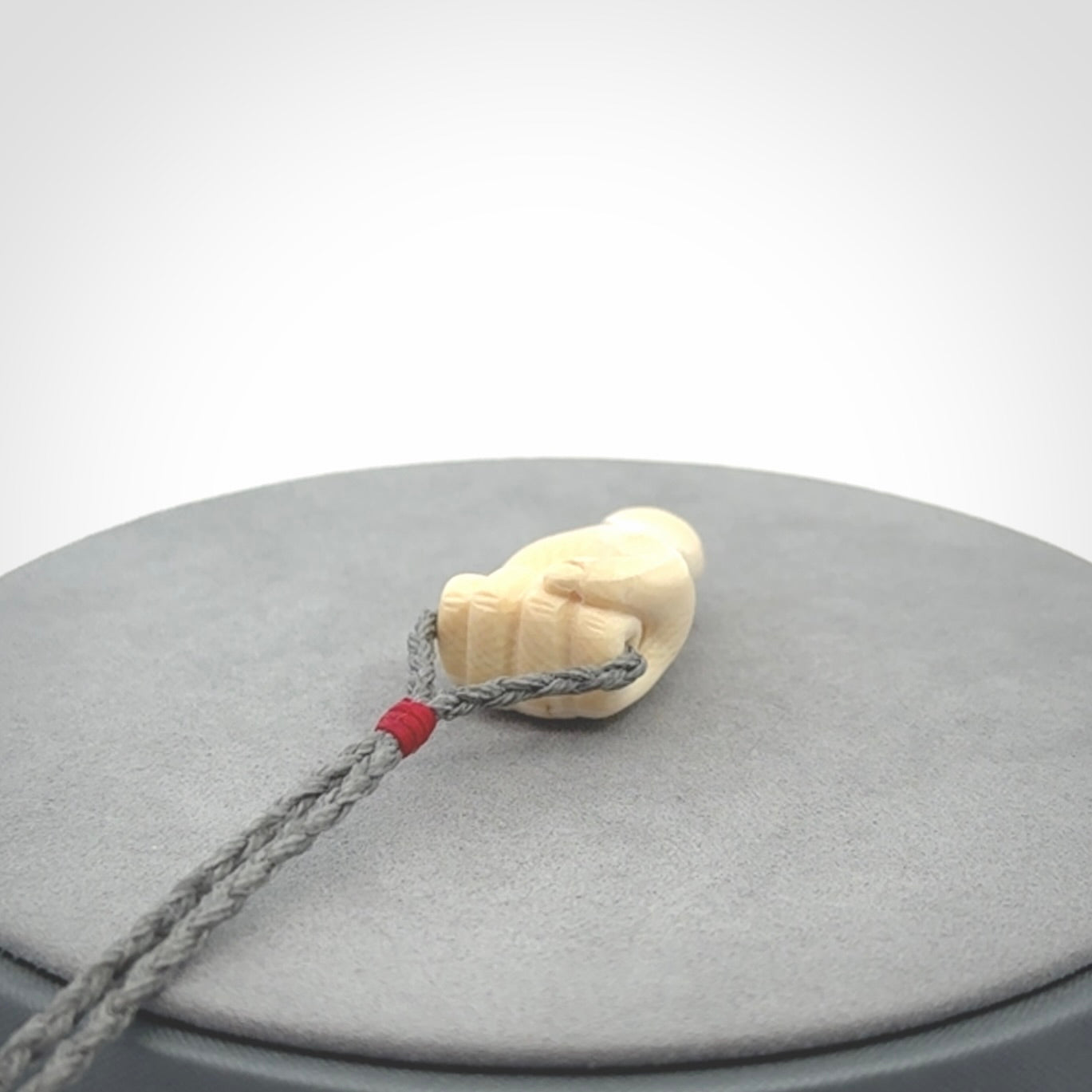 Hand carved fist pendant symbolising strength and hope. Carved by NZ Pacific from ancient woolly mammoth tusk.