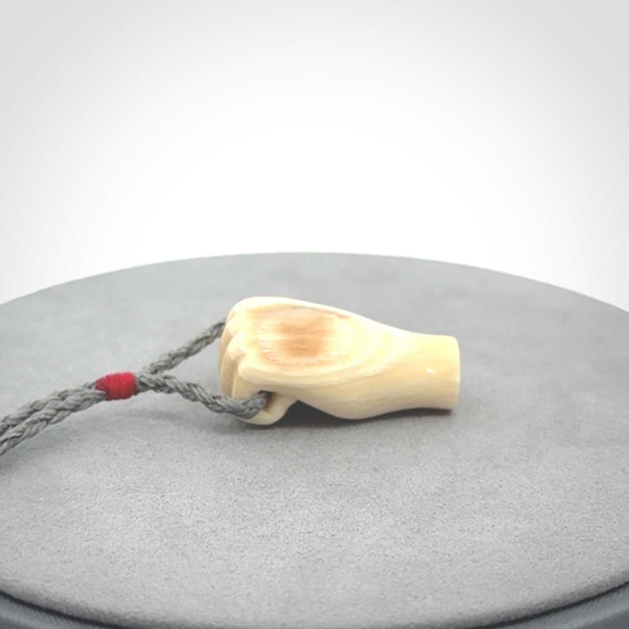 Hand carved fist pendant symbolising strength and hope. Carved by NZ Pacific from ancient woolly mammoth tusk.