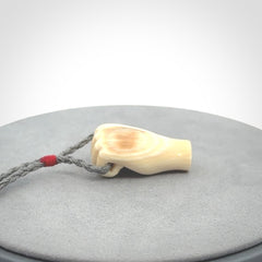 Hand carved fist pendant symbolising strength and hope. Carved by NZ Pacific from ancient woolly mammoth tusk.
