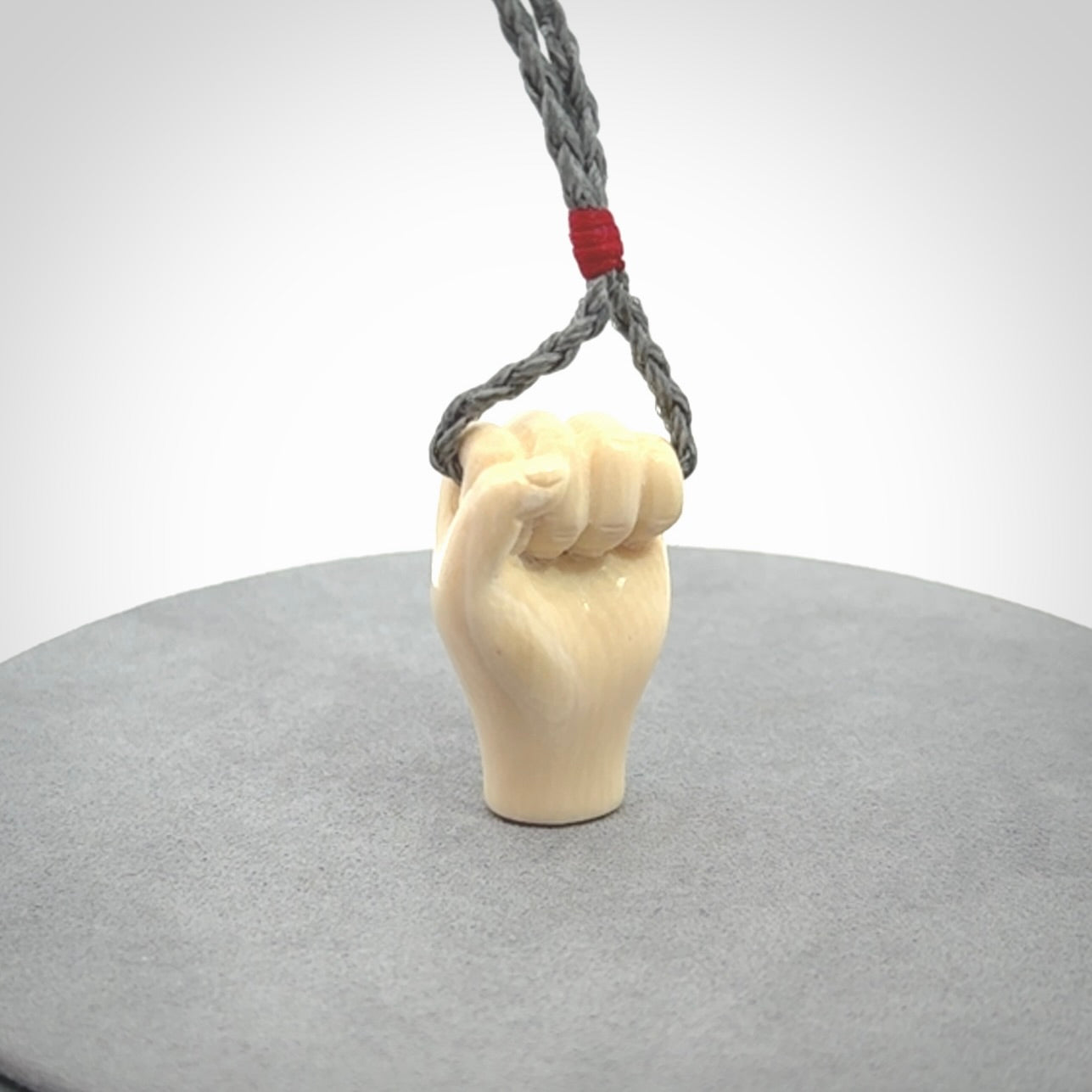 Hand carved fist pendant symbolising strength and hope. Carved by NZ Pacific from ancient woolly mammoth tusk.