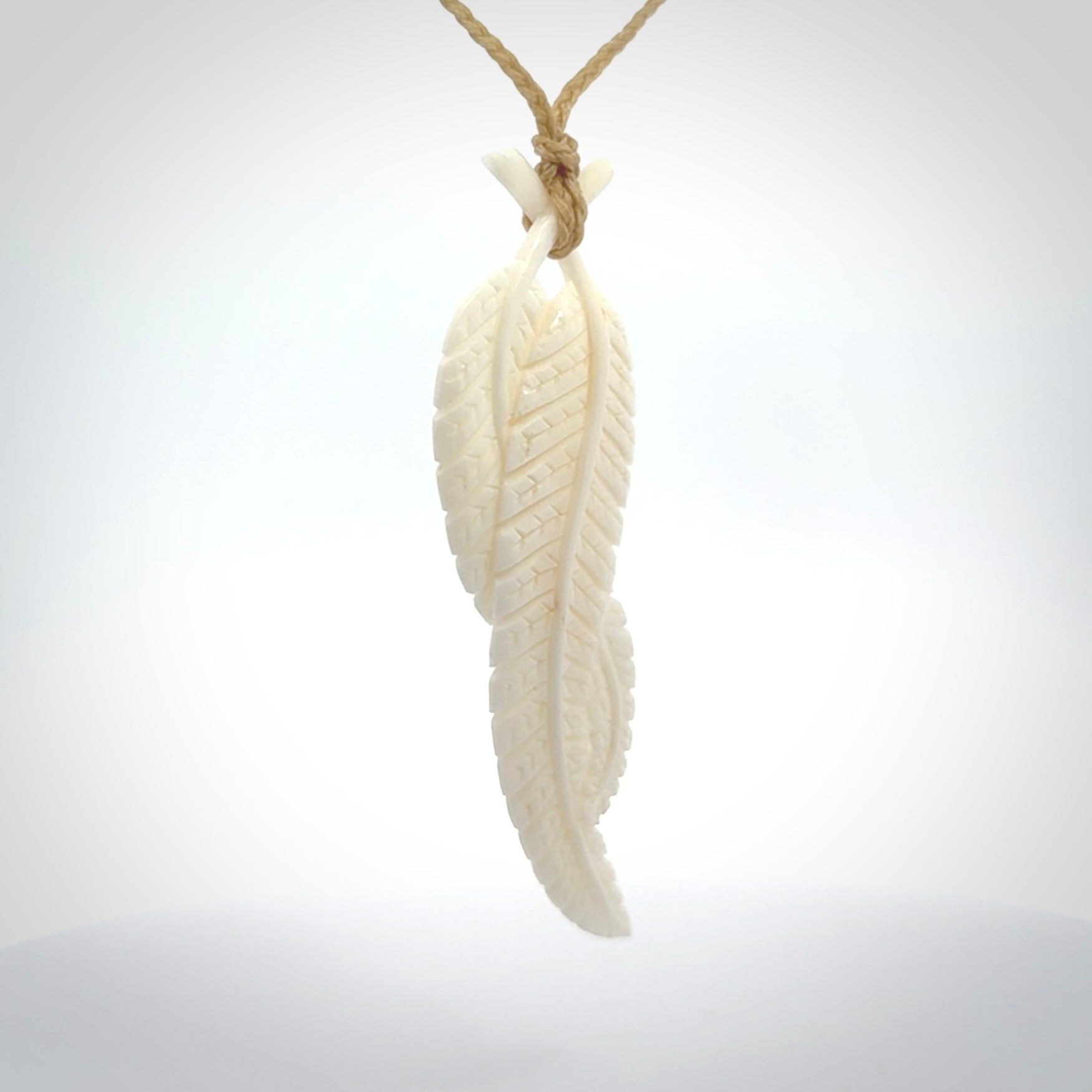 A hand carved large bone double fern leaf necklace. A beautiful large double fern leaf pendant carved from bone for NZ Pacific. This is a true piece of wearable art and is provided with an adjustable cord.